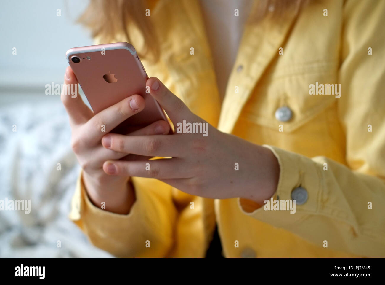 Teen holding iphone 7 using social media Stock Photo