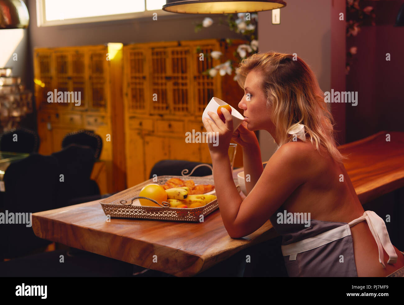 pregnant slut Young blond pregnant woman wearing cover-slut sitting and drinking a tea,  coffee in kitchen at home alone Stock Photo - Alamy