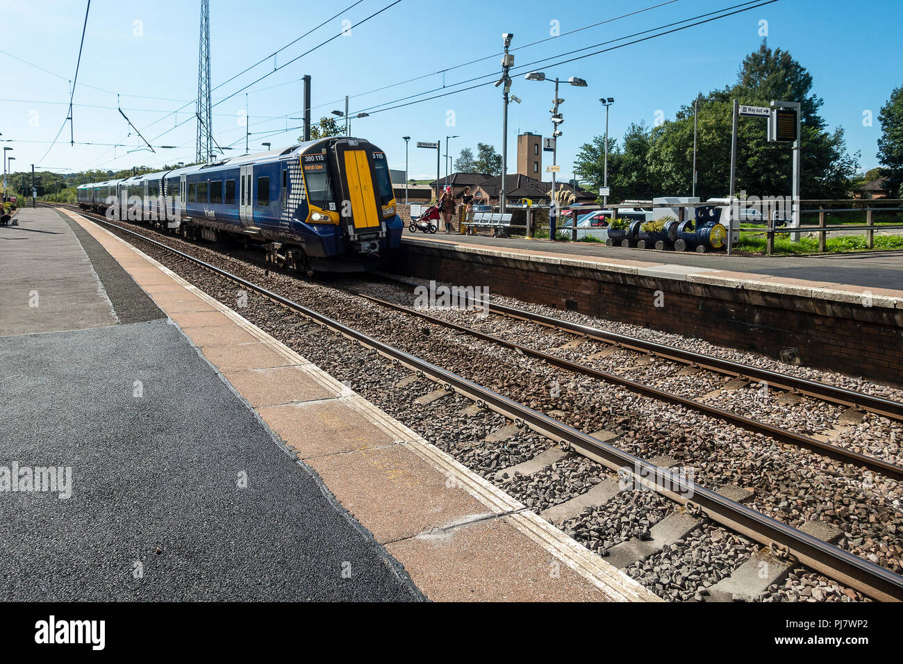 A Siemens Class 380 Desiro electric multiple-unit train (ScotRail run by Abellio) arriving at the halt in Dalry, North Ayrshire en route to Glasgow. Stock Photo