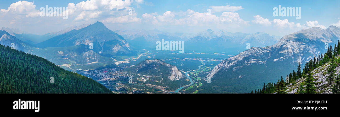 Panorama of mountain ranges as viewed from Sulphur Mountain in Banff National Park, Alberta, Canada, showing Banff townsite, the Bow River and surroun Stock Photo