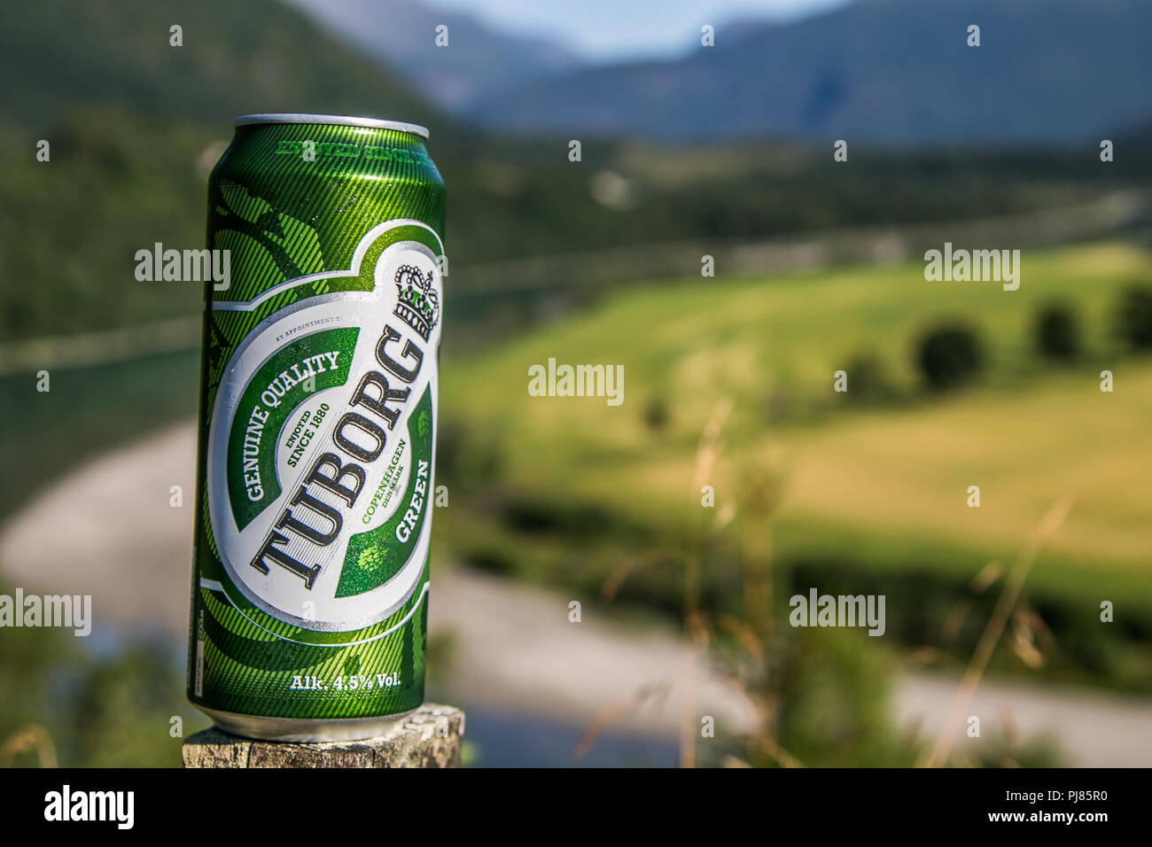 Norway, July 27, 2018: Can of Tuborg beer stands against beautiful natural backdrop. Stock Photo