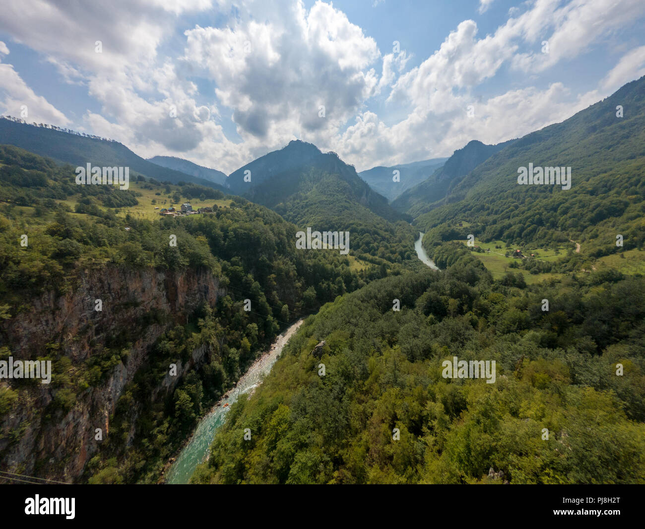 River flowing through a deep valley surrounded with forest Stock Photo