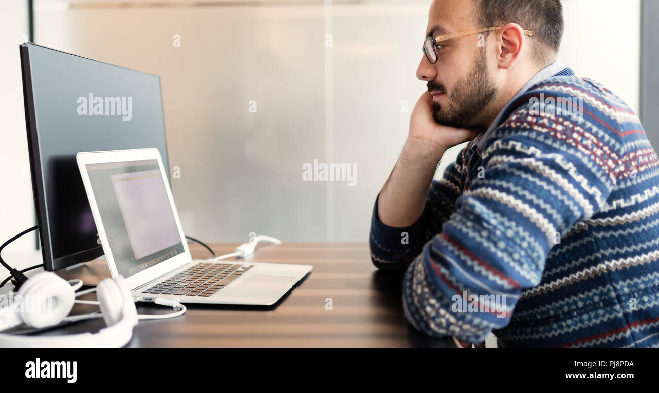 Software engineer programming in office Stock Photo - Alamy