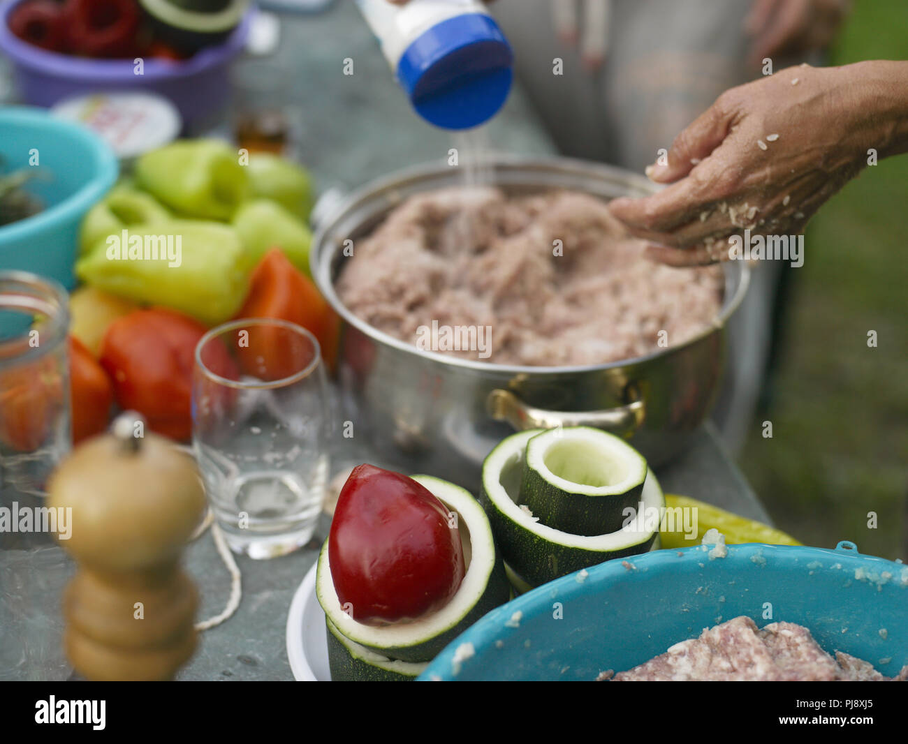 Selective focus shot of a cooking process with hand salting food in the ...
