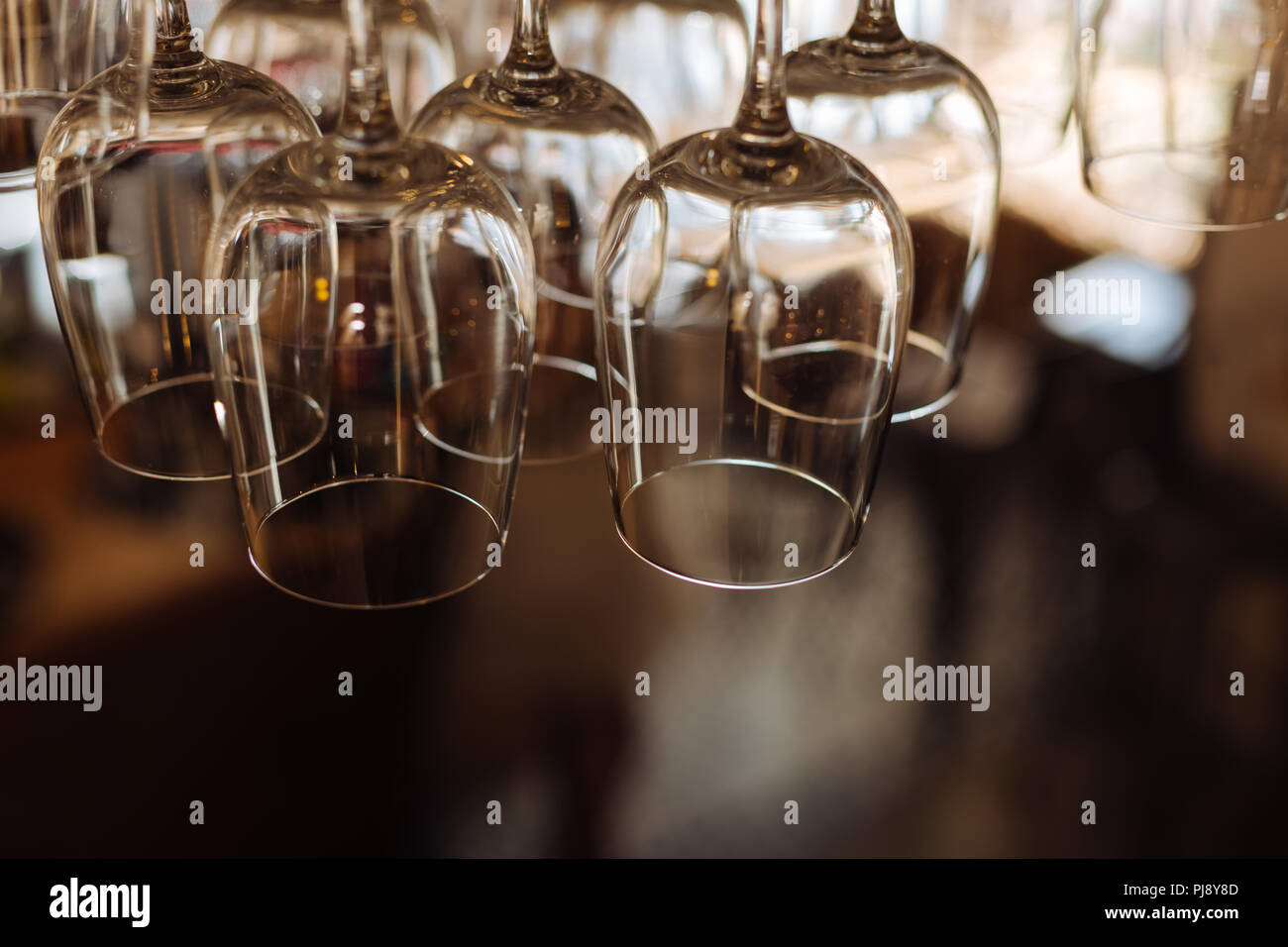 Close up of clean wine glasses hanging upside down Stock Photo Alamy