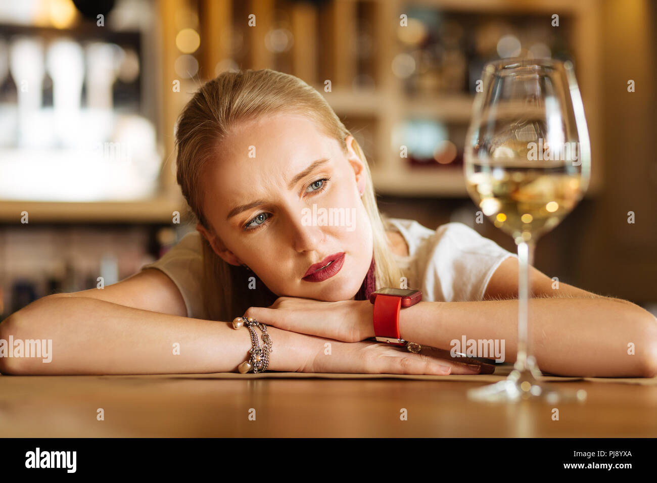 Woman looking glass wine sad hi-res stock photography and images - Alamy