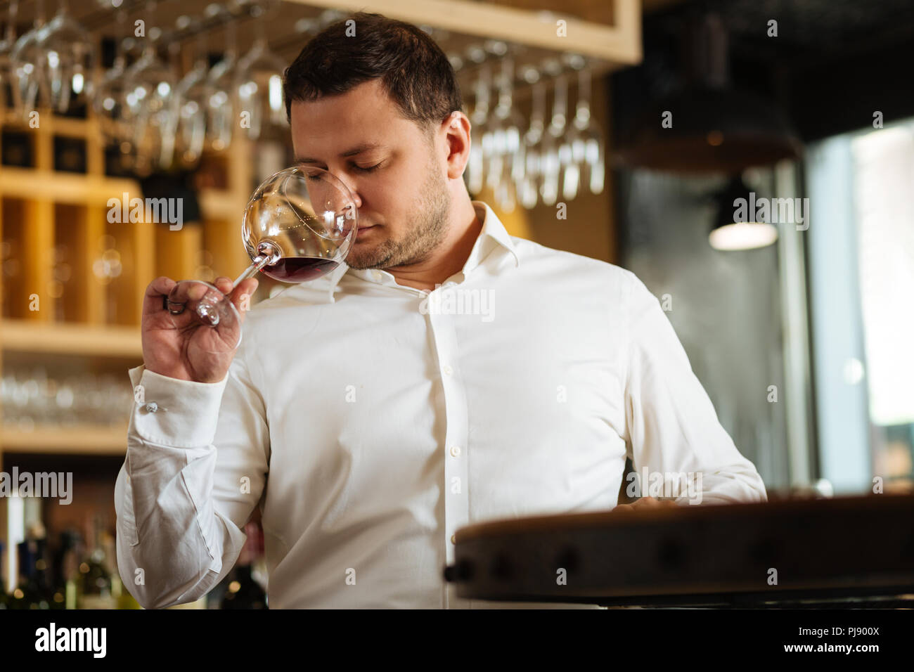 Nice good looking man holding a glass with red wine Stock Photo