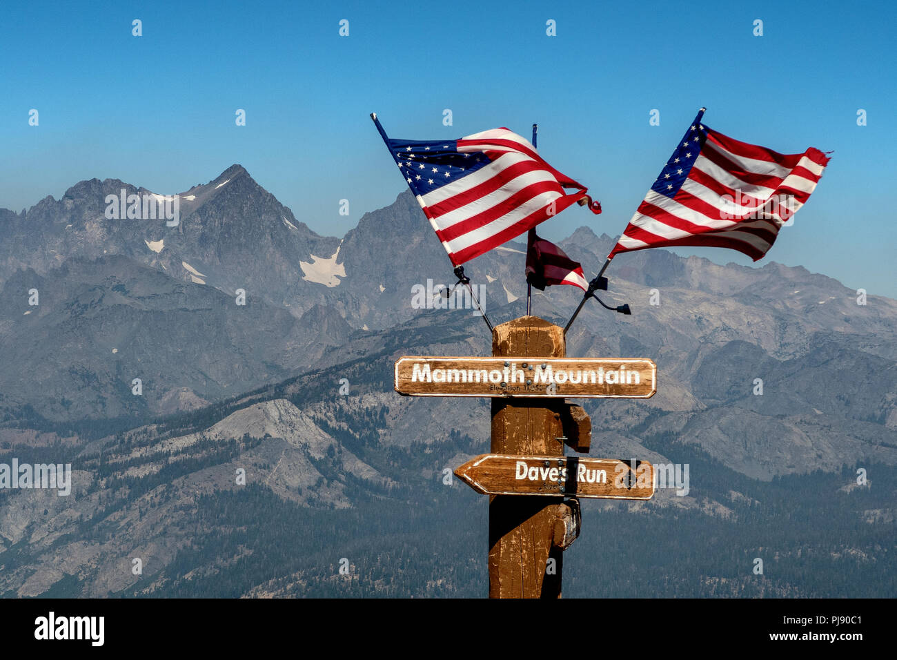 American flags on a post at the summit of Mammoth Mountain in California. Stock Photo