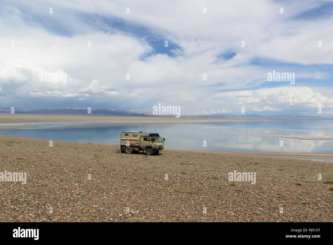 The Khyargas Nuur, A salt water lake in Khyargas district, Mongolia. Overlander campertruck parked beside it Stock Photo