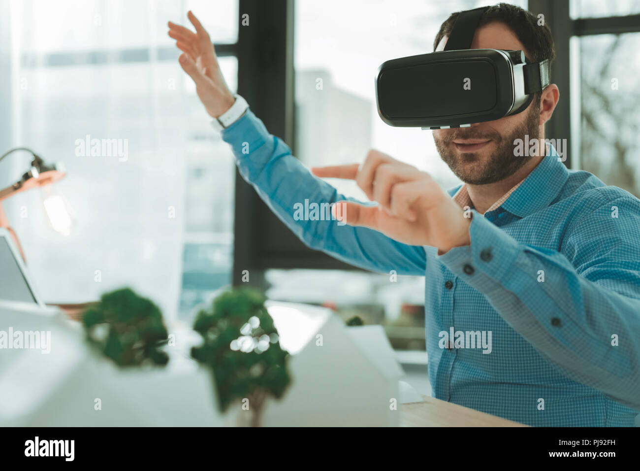 Positive smart man using virtual reality glasses Stock Photo