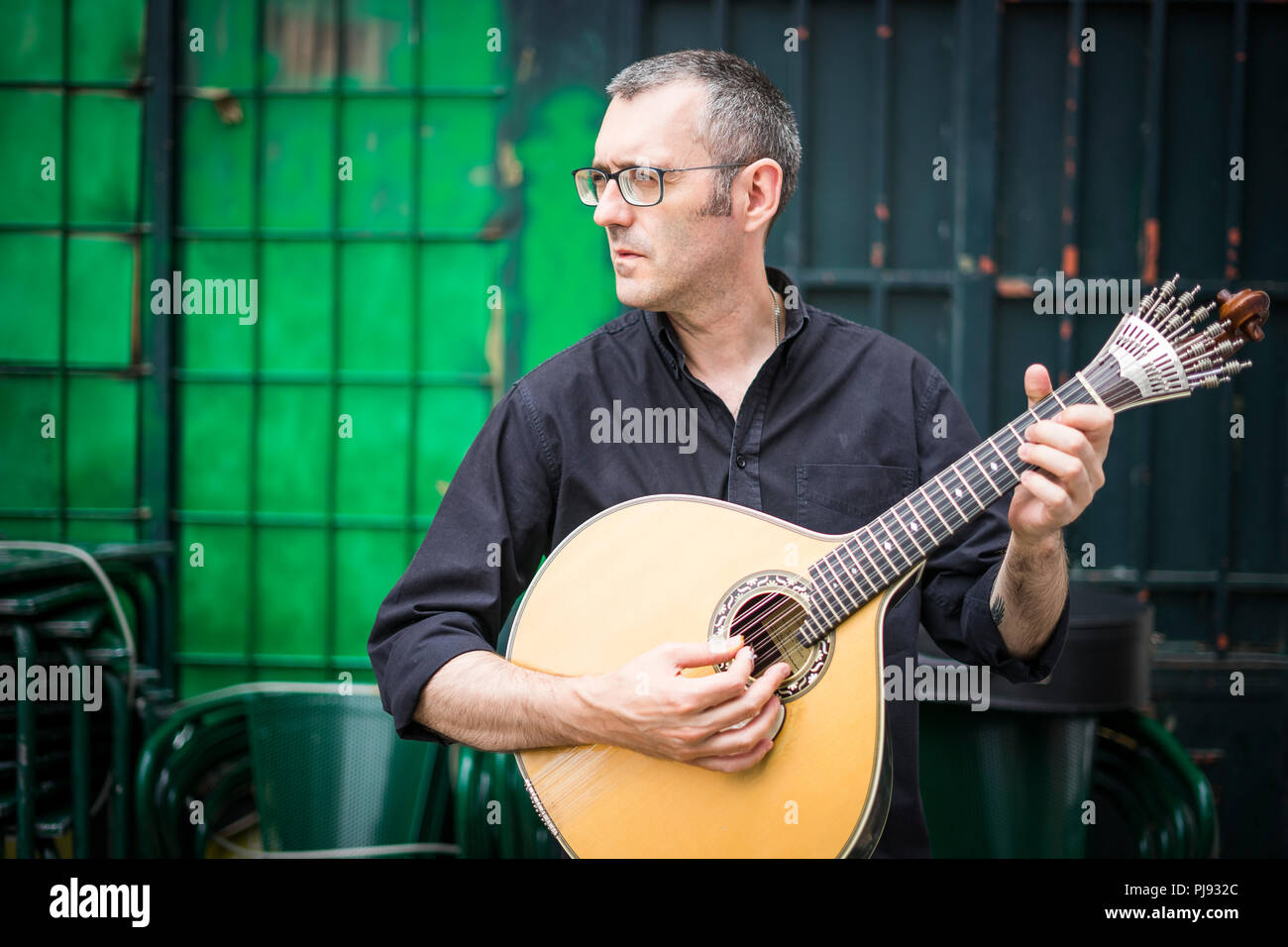 Musician with his beloved  portuguese guitar on the street of Lisbon, Portugal Stock Photo