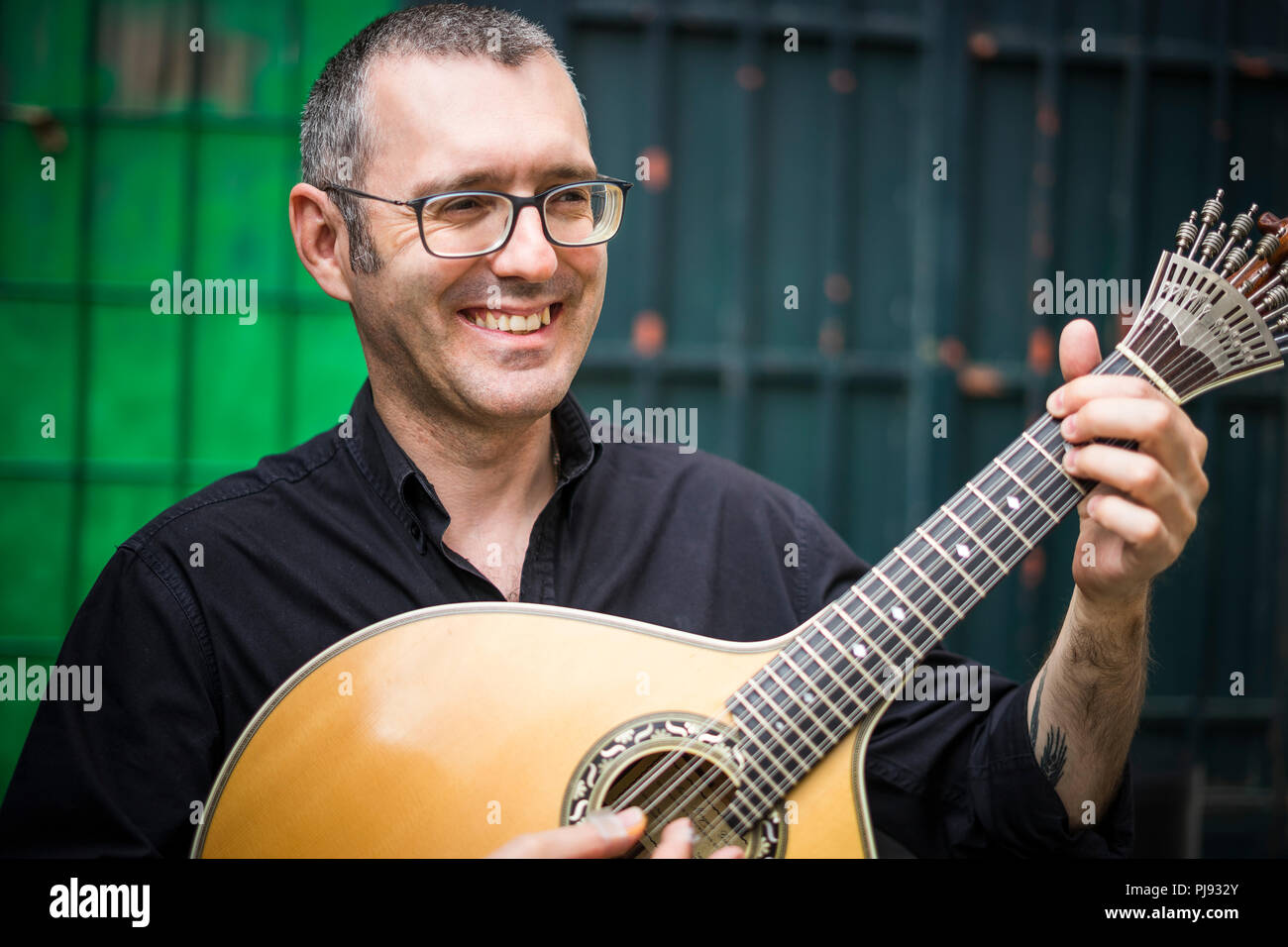 Musician with his beloved portuguese guitar on the street of Lisbon