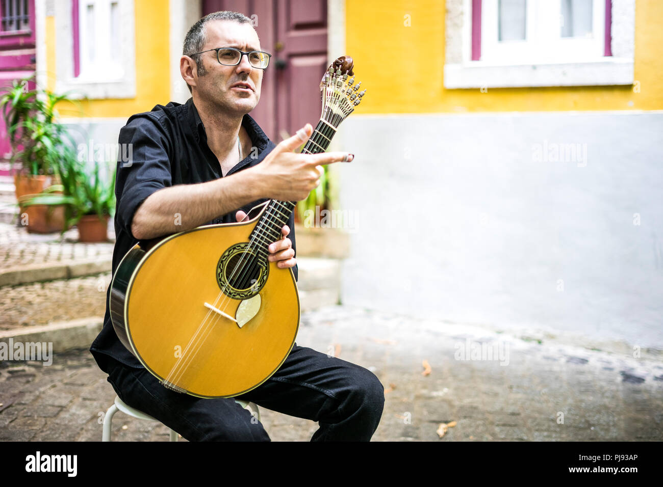Musician with his beloved  portuguese guitar on the street of Lisbon, Portugal Stock Photo