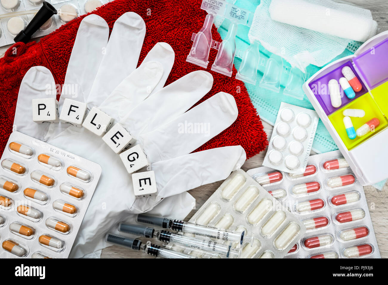 Latex gloves, tablets and nursing utensils, geriatric care, nursing crisis, symbolic photo, Latexhandschuhe, Tabletten und Pflege-Utensilien, Altenpfl Stock Photo