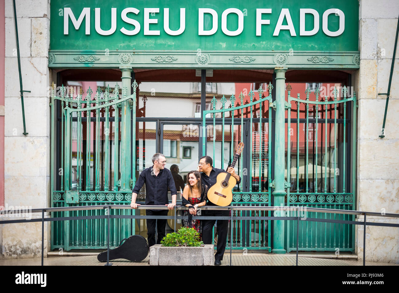 Portuguese guitar player, fado singer and acoustic guitar player in front of Fado Museum in Lisbon, Portugal Stock Photo