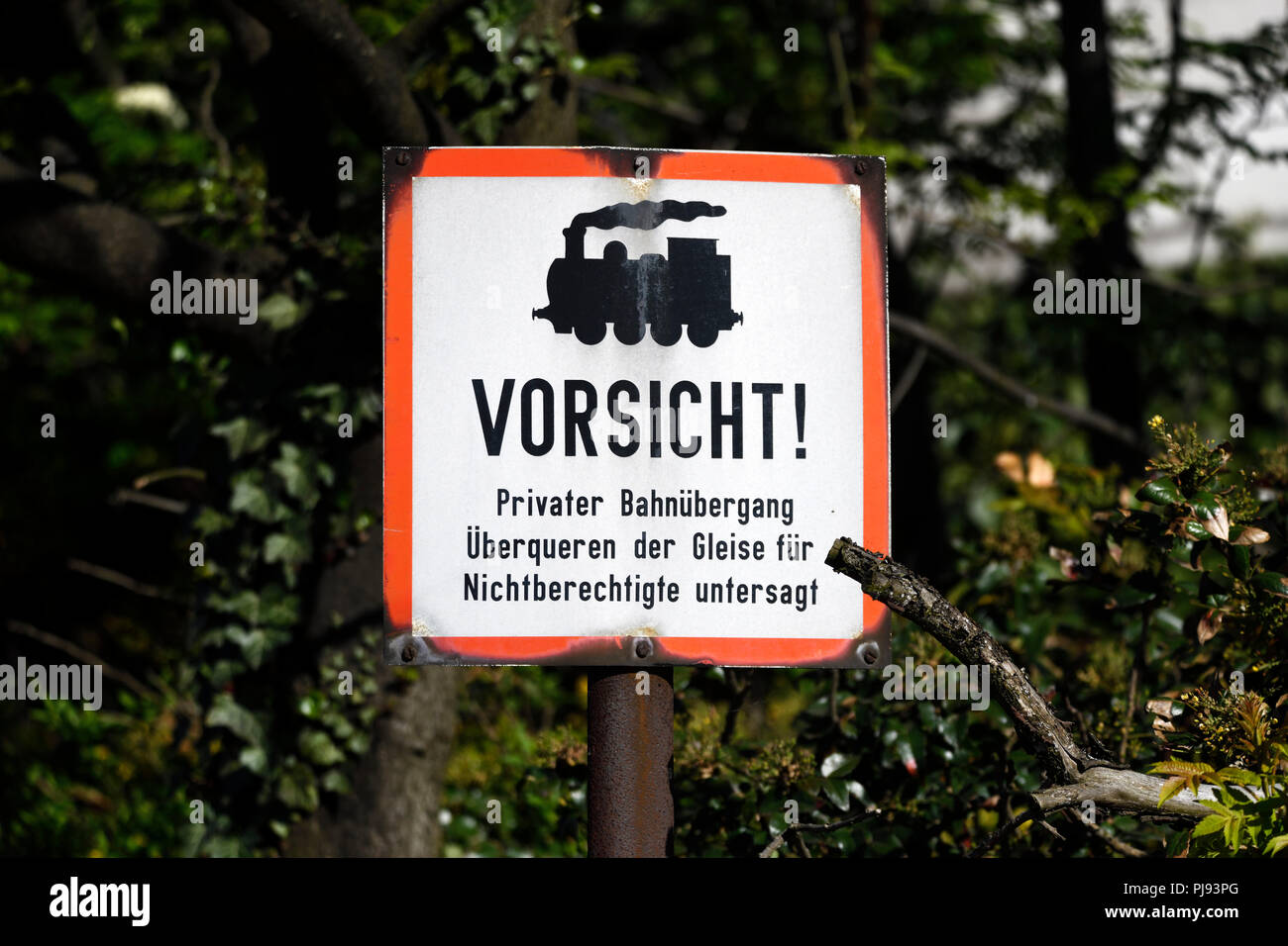 Old warning at a level crossing in Hamburg, Germany, Europe, Altes Warnschild an einem Bahnübergang in Hamburg, Deutschland, Europa Stock Photo