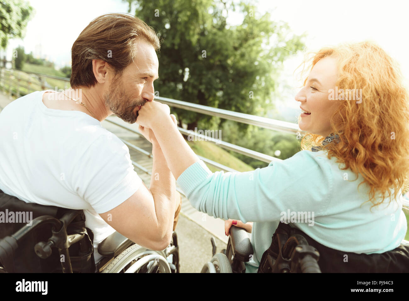 Fell in love mature man kissing hand of woman Stock Photo