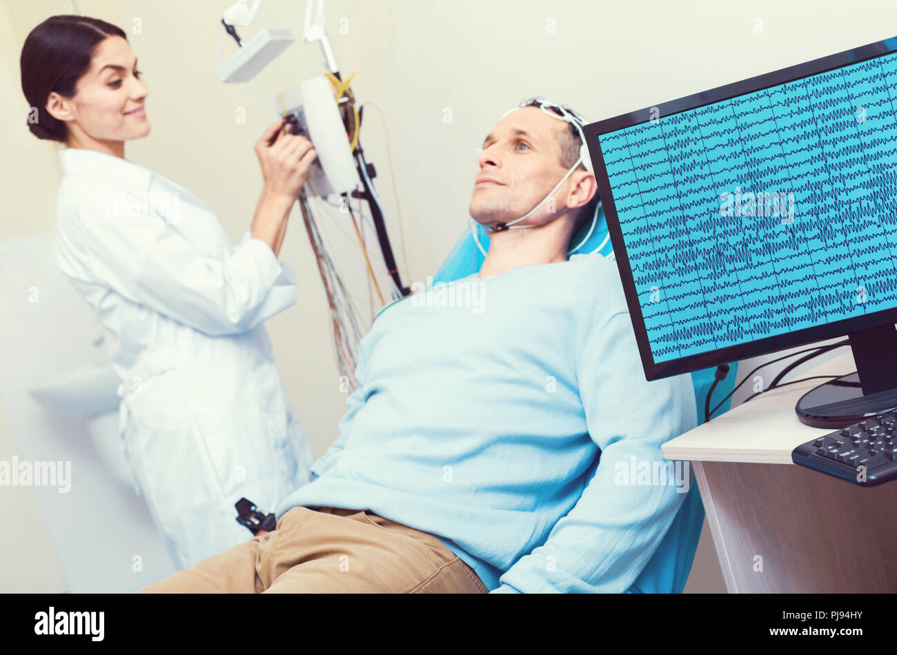 Computer recording brain waves of mature gentleman Stock Photo