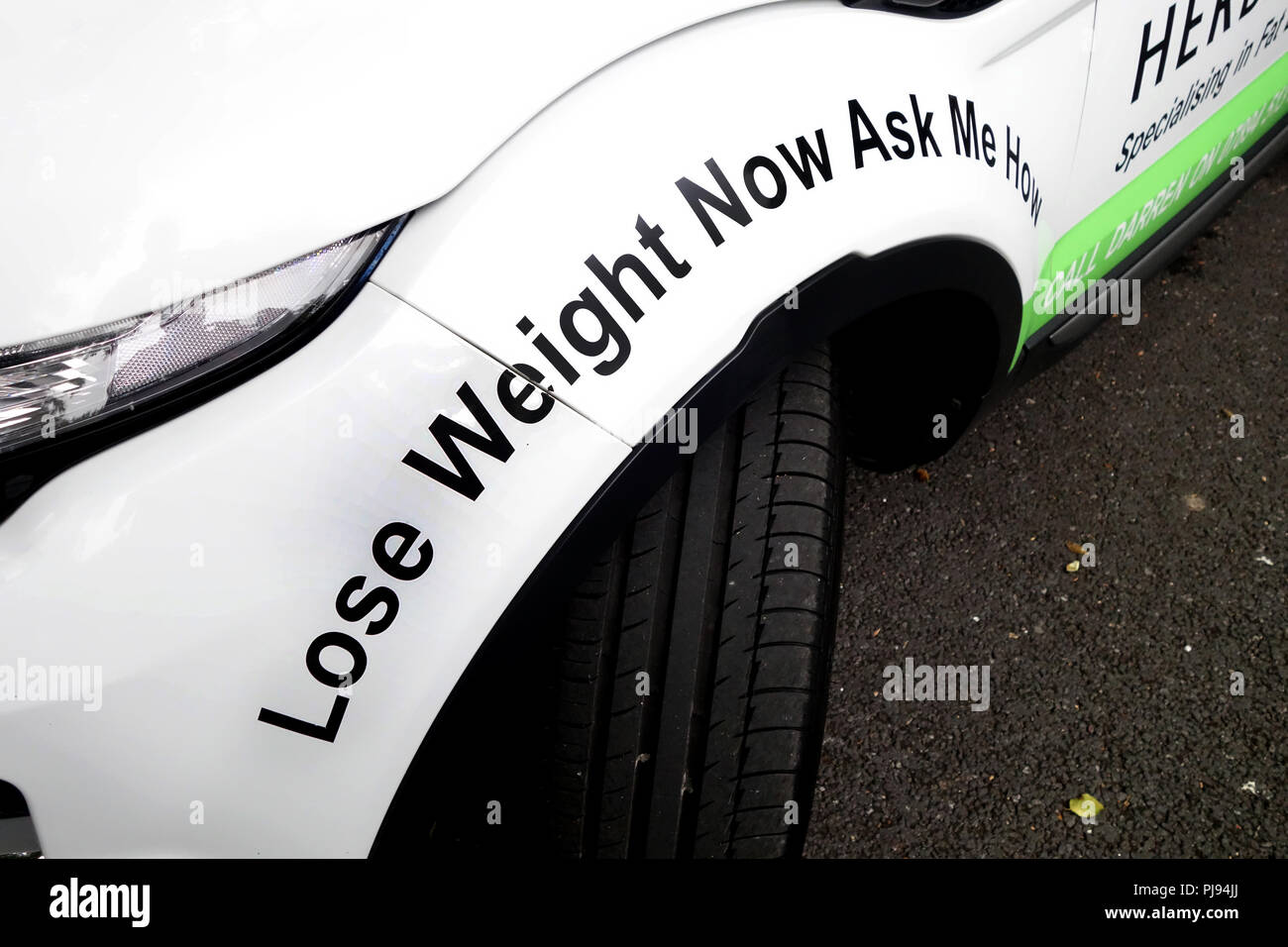 ' Lose weight now, ask me how' written on a wheel arch on a Herbalife ...
