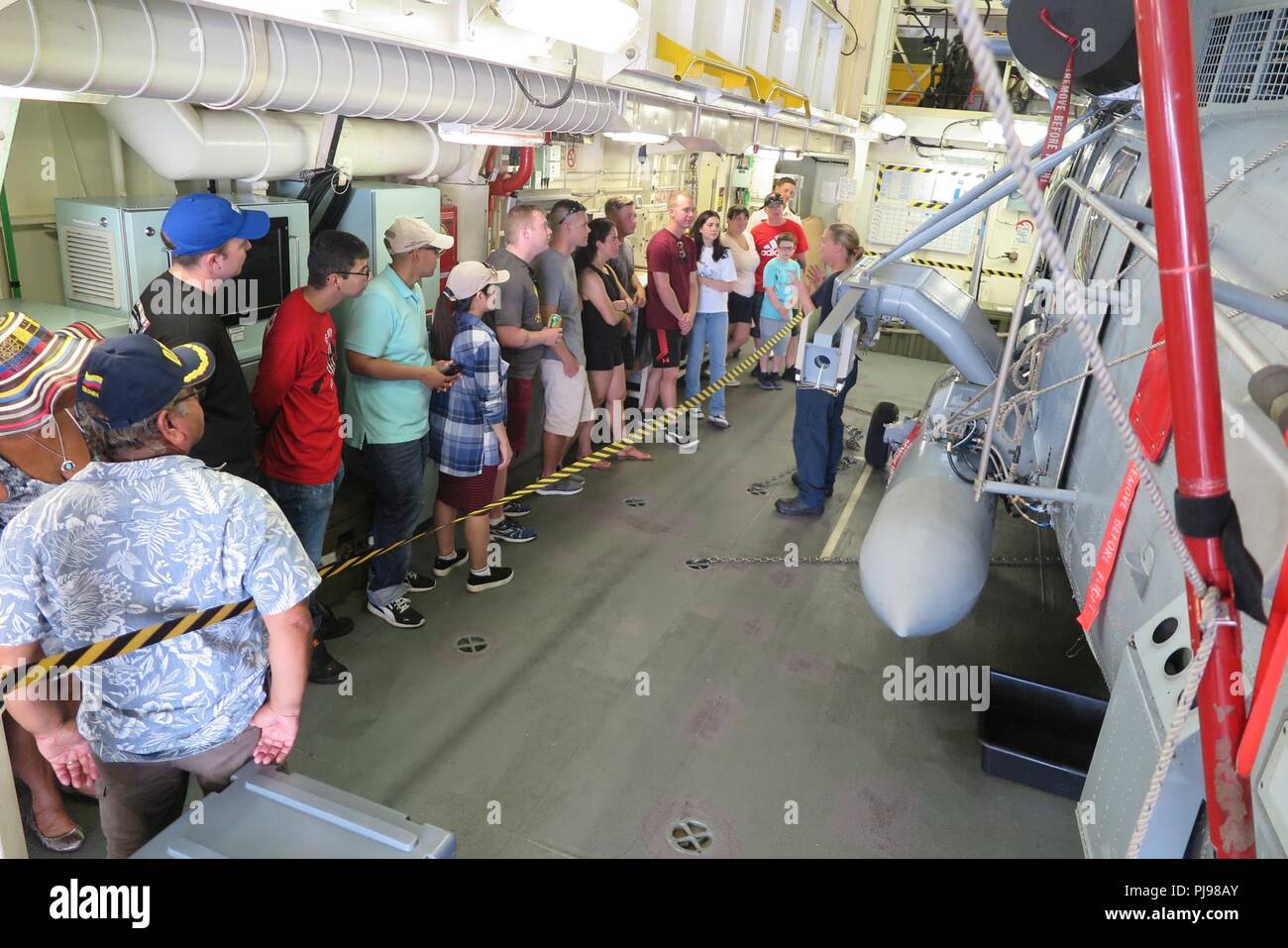 JOINT BASE PEARL HARBOR-HICKAM, Hawaii (July 7, 2018) Royal New Zealand Navy (RNZN) Sub Lt. Jules Double answers questions from the public during their visit to RNZN frigate HMNZS Te Mana (F111) during an open ship day held at Joint Base Pearl Harbor-Hickam, July 7. During the event, ships from nations participating in Rim of the Pacific (RIMPAC) exercise opened their brows to sailors and families. Twenty-five nations, 46 ships, five submarines, about 200 aircraft, and 25,000 personnel are participating in RIMPAC from June 27 to Aug. 2 in and around the Hawaiian Islands and Southern California Stock Photo