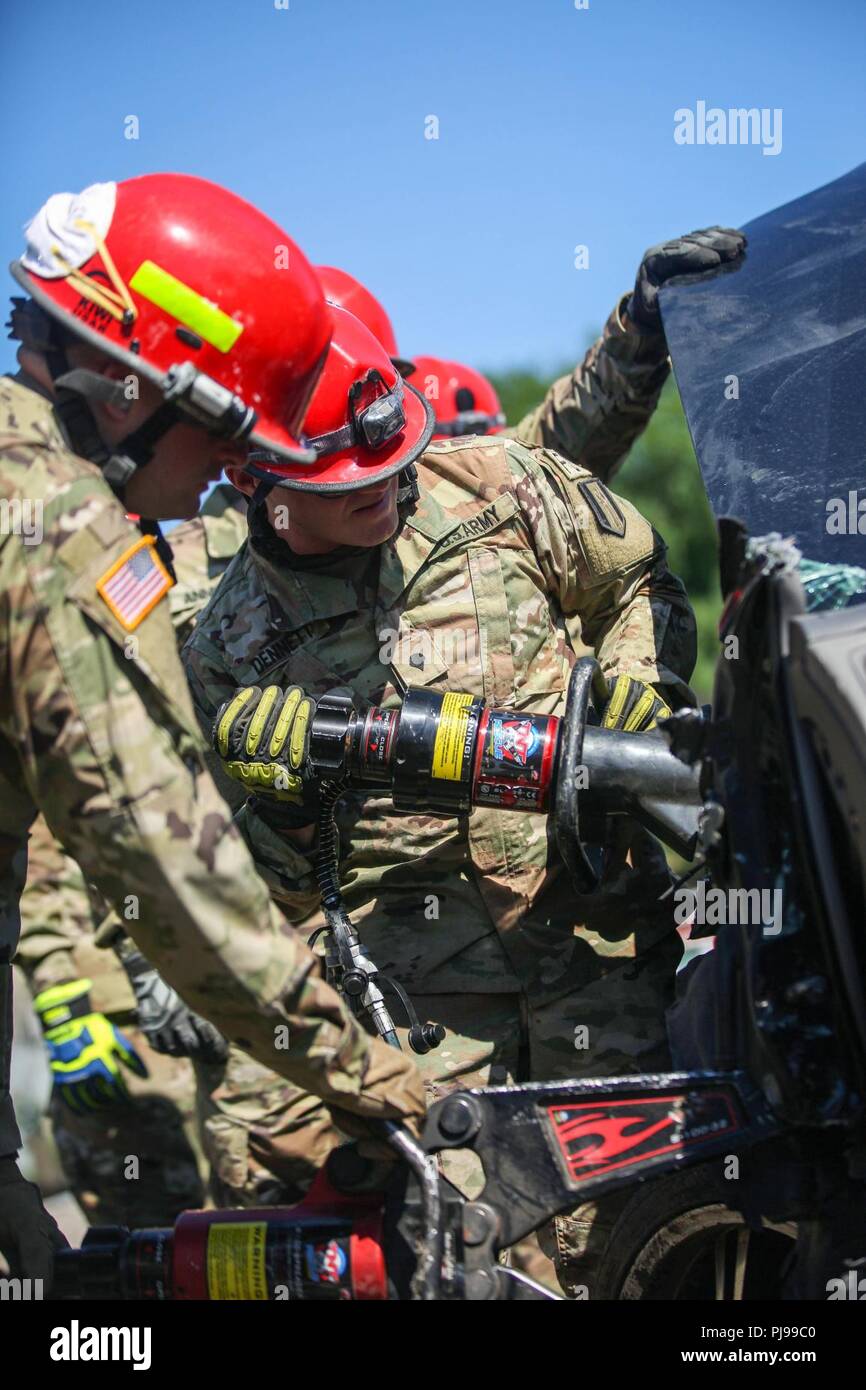 U.S. Army Spc. Ryan Dunnett, assigned to the 287th Engineer Detachment, trains at the The New York City Fire Department Academy, New York City, New York, on July 9, 2018. SPC Dunnett is training on the Jaws of Life. A hydraulic apparatus used to pry apart the wreckage of crashed vehicles in order to free people trapped inside. New York City Fire Department (FDNY) with U.S. Army North, and U.S. Northern Command (NORTHCOM) conducts training as a joint exercise simulating Chemical, Biological, Radiological, and Nuclear (CBRN) events to maximize the appropriate  response from first responders. Stock Photo