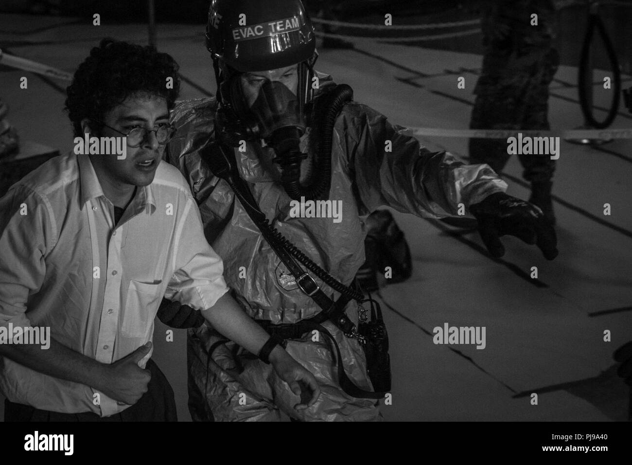 A firefighter with the New York City Fire Department (FDNY) escorts a casualty played by New York City University's drama department during a training event at the Time Square Church, New York City, New York, on July 10, 2018.  New York City Fire Department with U.S. Army North, and U.S. Northern Command (NORTHCOM) conducted training as a joint exercise simulating Chemical, Biological, Radiological, and Nuclear (CBRN) events to maximize the appropriate  response from first responders. Stock Photo