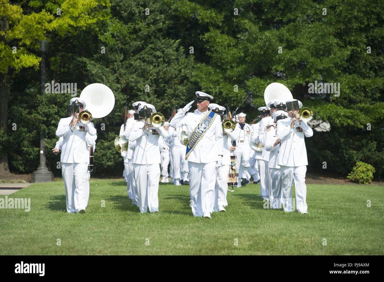 The U.S. Navy Band performs during the Joint Base Anacostia-Bolling Parade as the base celebrates its 100th Anniversary Jul 3, 2018. Bolling Field was officially dedicated on 1 July, 1918, after the property was purchased by the War Department and turned over to the Aviation Section of the Signal Corps to serve as the primary aviation facility for the capital city. This new military property was appropriately named for Colonel Raynal C. Bolling, an early vanguard in the quest for Army airmanship. Stock Photo