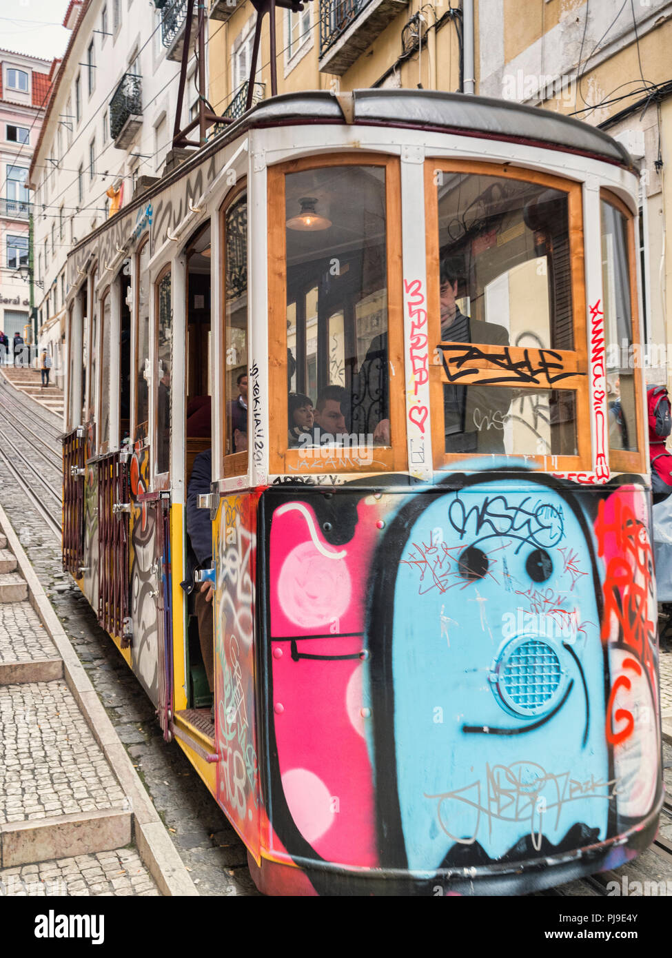 7 March 2018: Lisbon Portugal - The Bica Lift, or Elevador da Bica, decorated with graffiti, in the Misericordia district, a funicular railway line Stock Photo