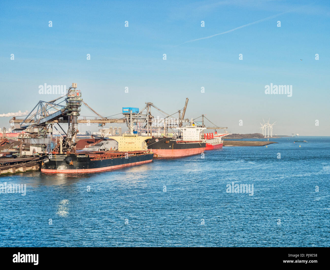 6 April 2018: Rotterdam, Netherlands - Bulk carriers Horizon 2 and Milos Warrior being loaded at Port of Rotterdam on a sunny spring morning with clea Stock Photo