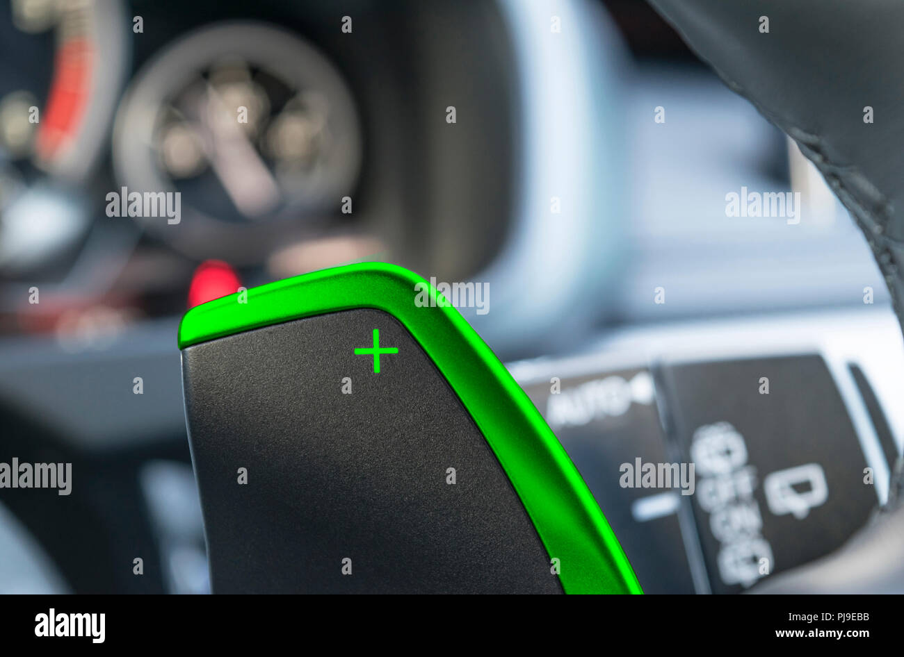 Manual gear changing stick on a car's steering wheel, car interior details.  Car detailing. Speedshift Stock Photo - Alamy