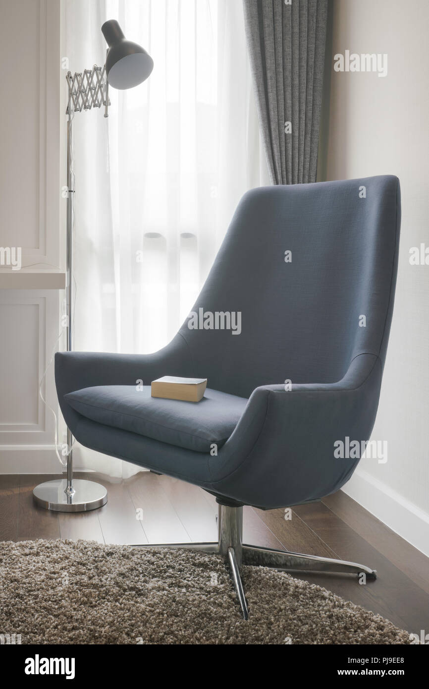 Stylish armhair with standing lamp in living room Stock Photo - Alamy