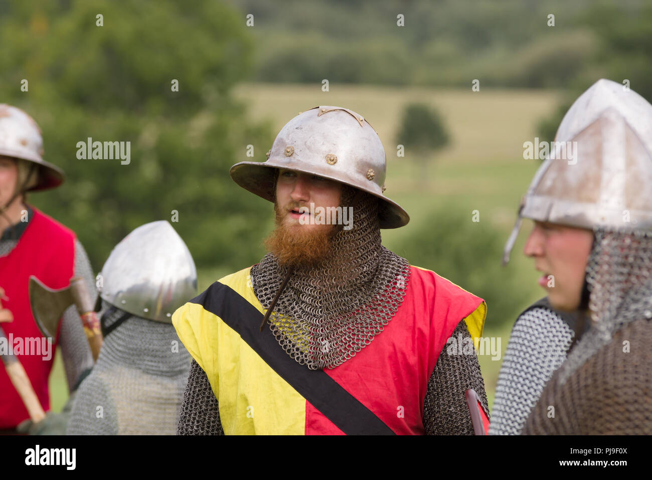 Medieval battle re-enactor of the Cwmwd Ial society wearing a kettle hat helmet  during a re-enactment of the battle of Crogen 1165 in North Wales Stock Photo