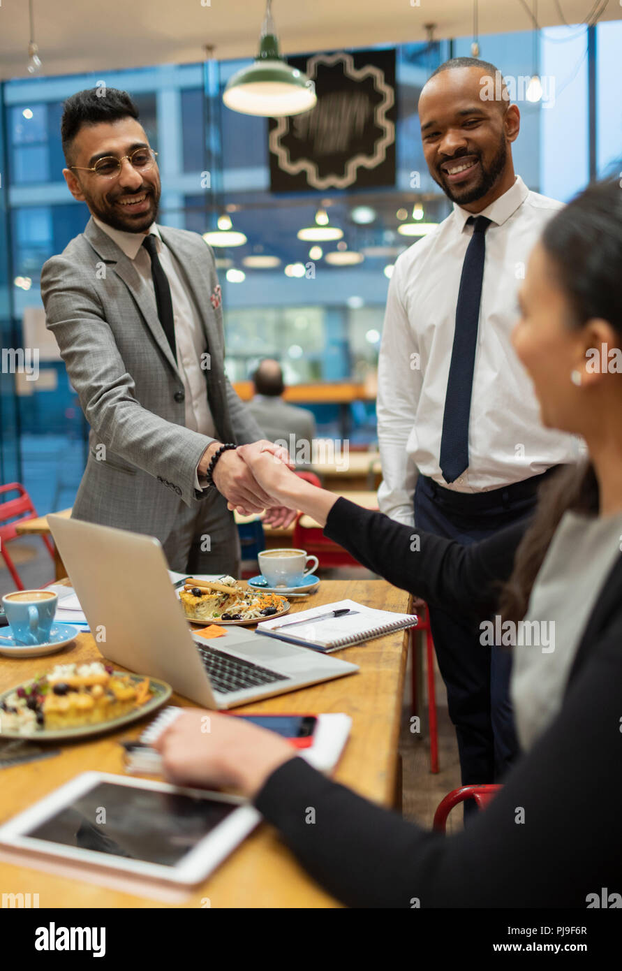 Business people handshaking, working in cafe Stock Photo