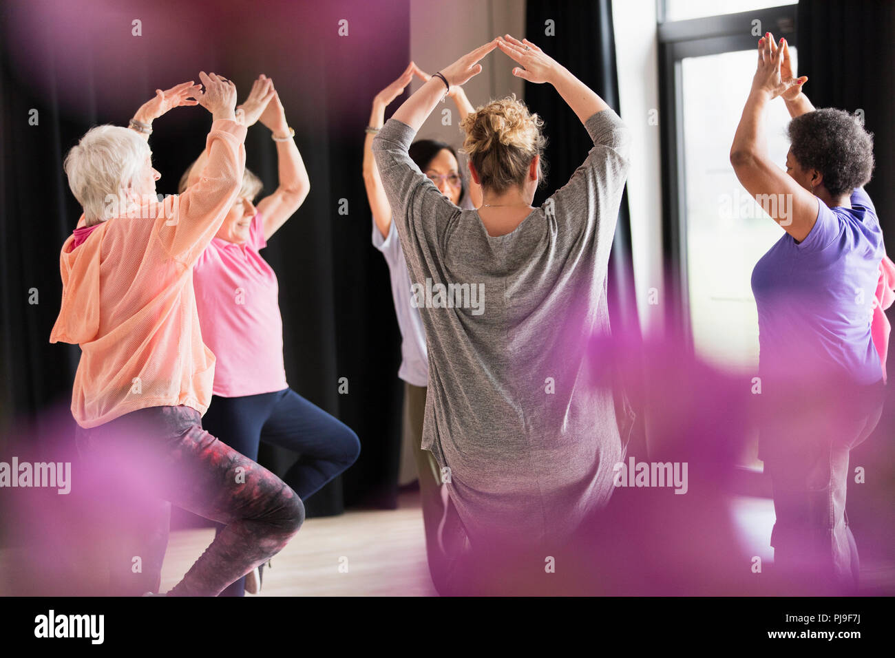Active seniors exercising in circle Stock Photo
