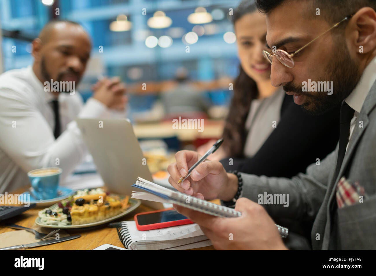 Business people writing, working in cafe Stock Photo