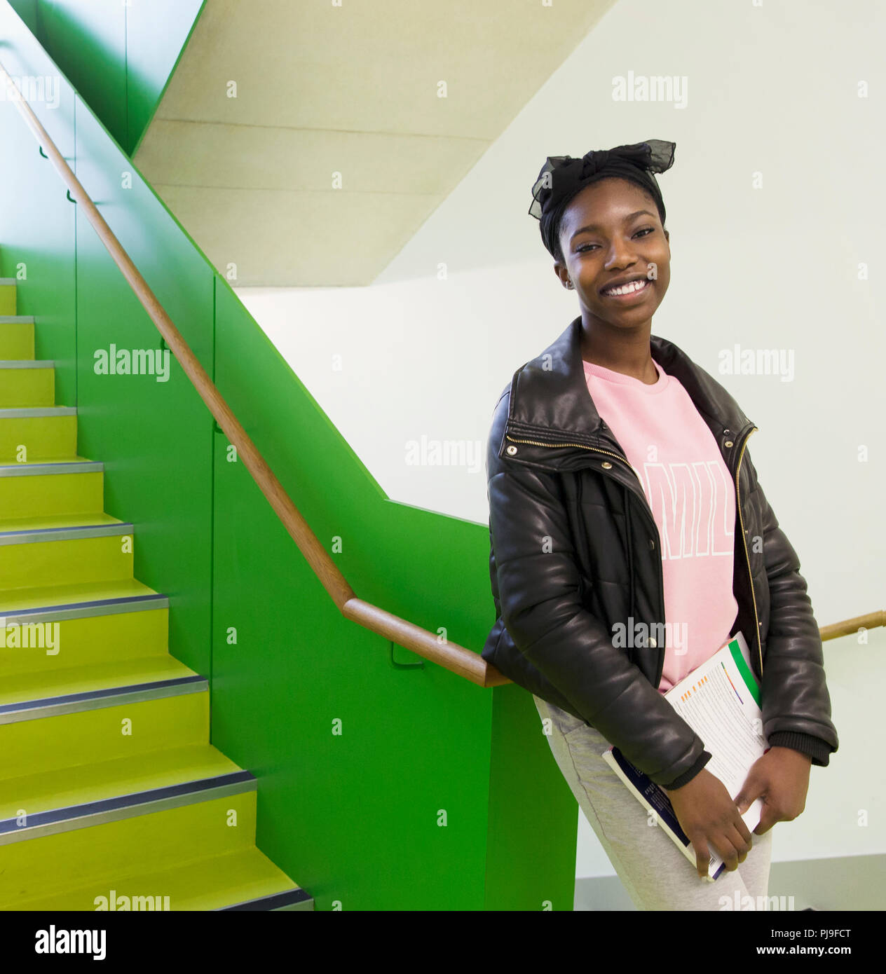 Portrait smiling, confident high school girl in stairway Stock Photo