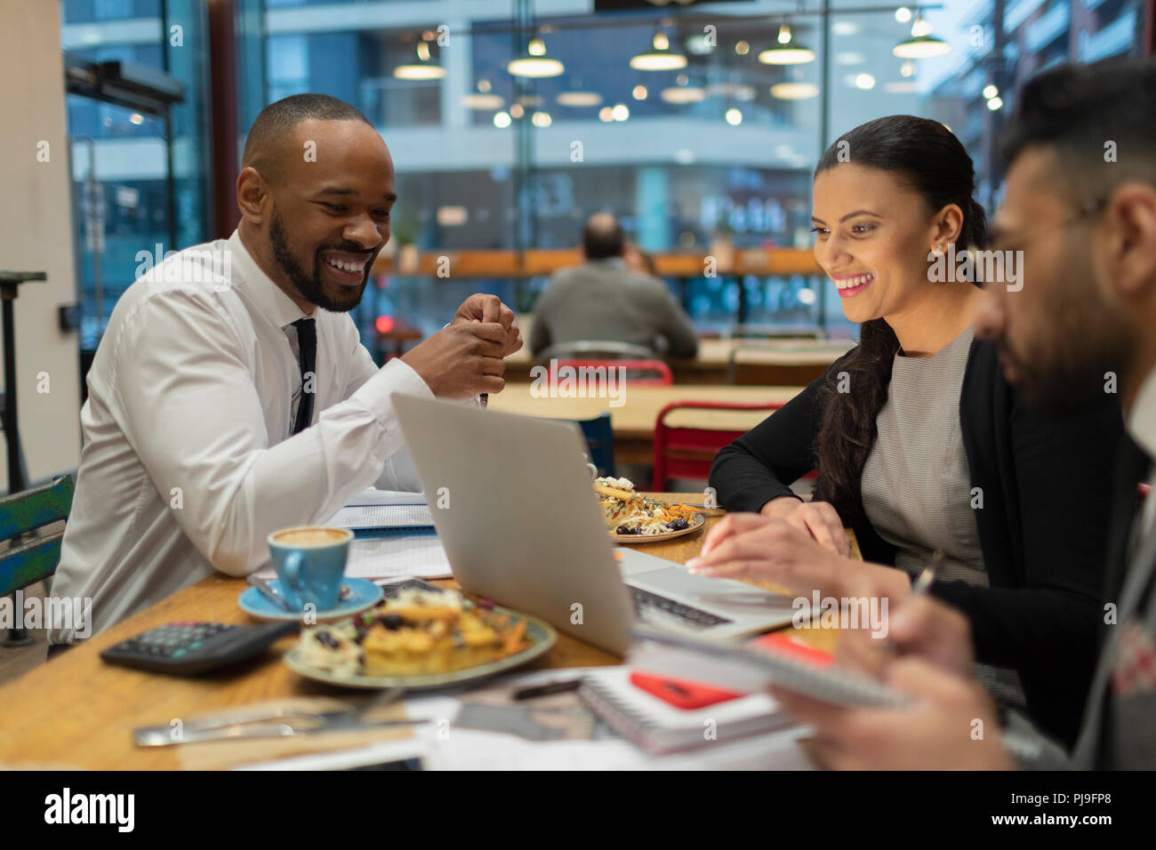 Business people meeting, working at laptop in cafe Stock Photo
