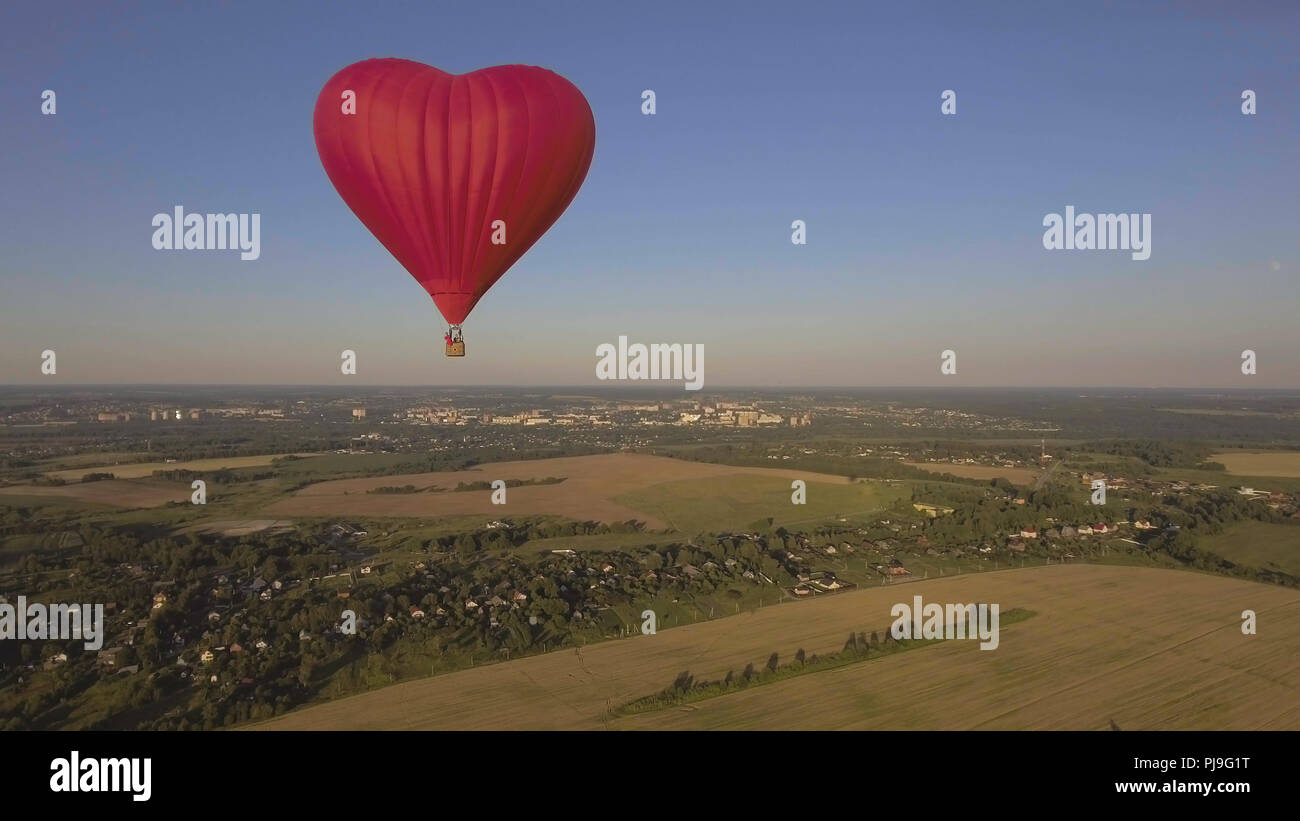 Hot air balloon shape of a heart in the blue sky. Aerostat, Airship ...