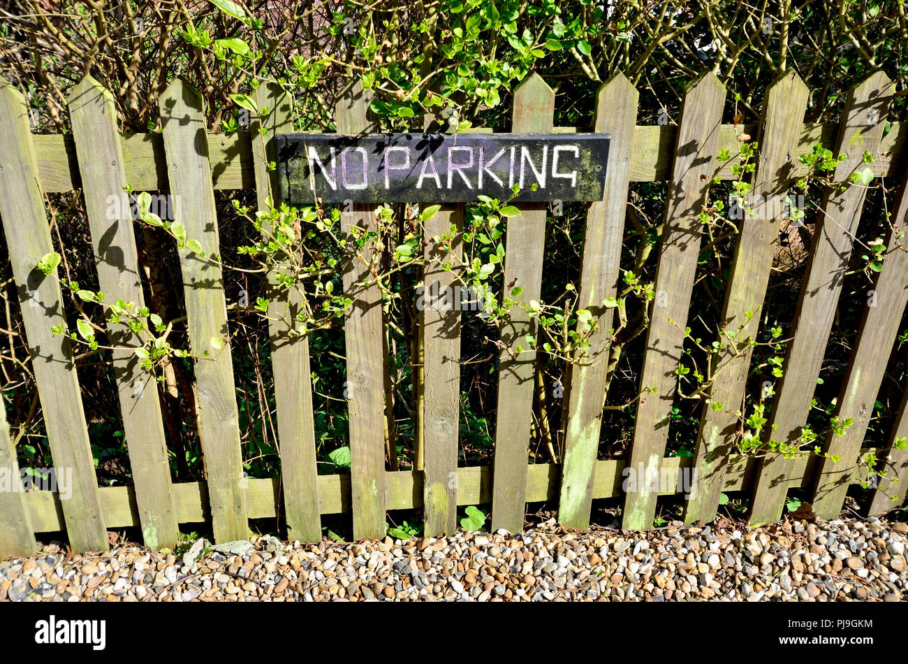 No Parking sign on a garden fence next to a roadLoose Village, Maidstone, Kent, UK. Stock Photo