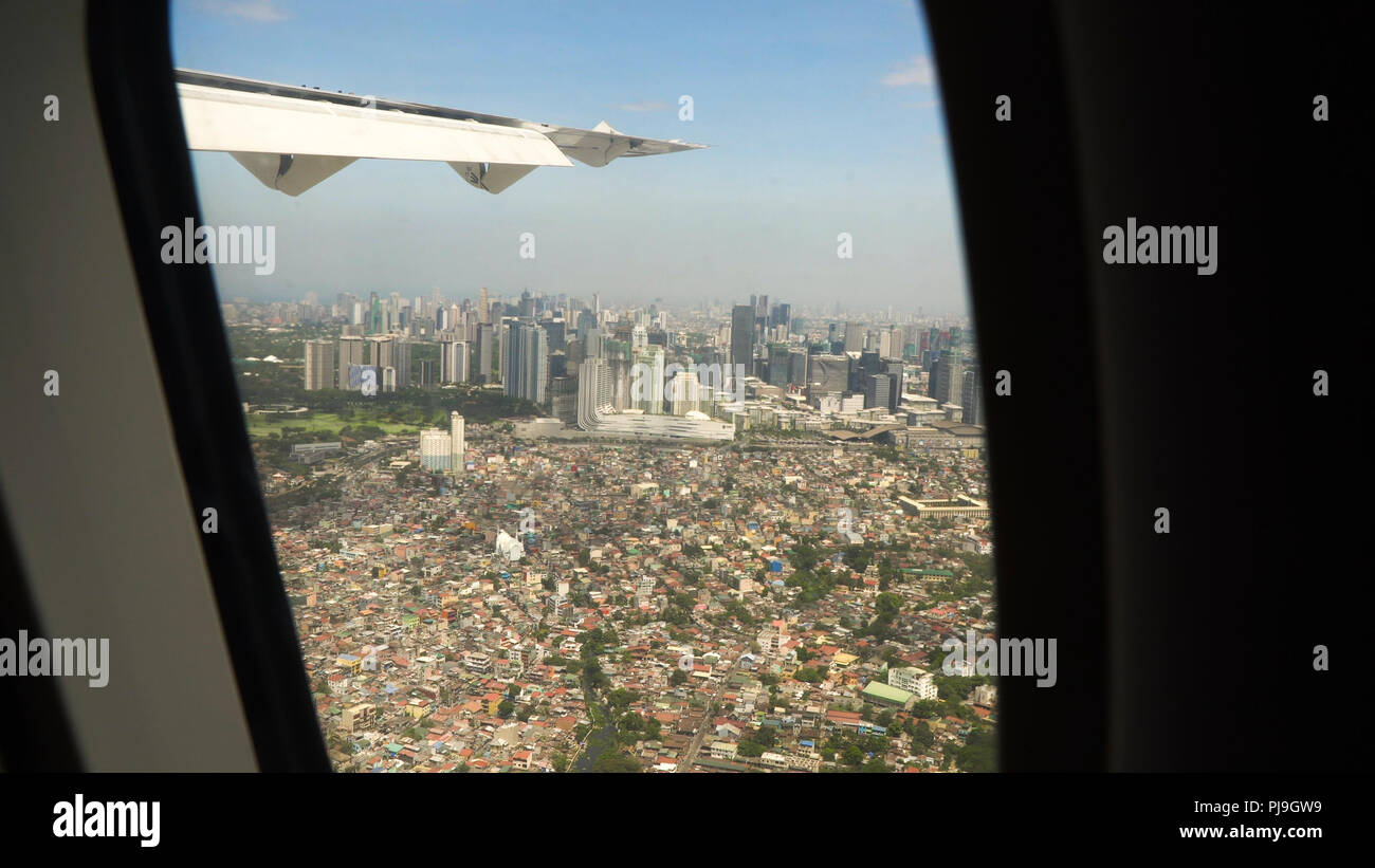 View through an airplane window on the city. Airplane window view