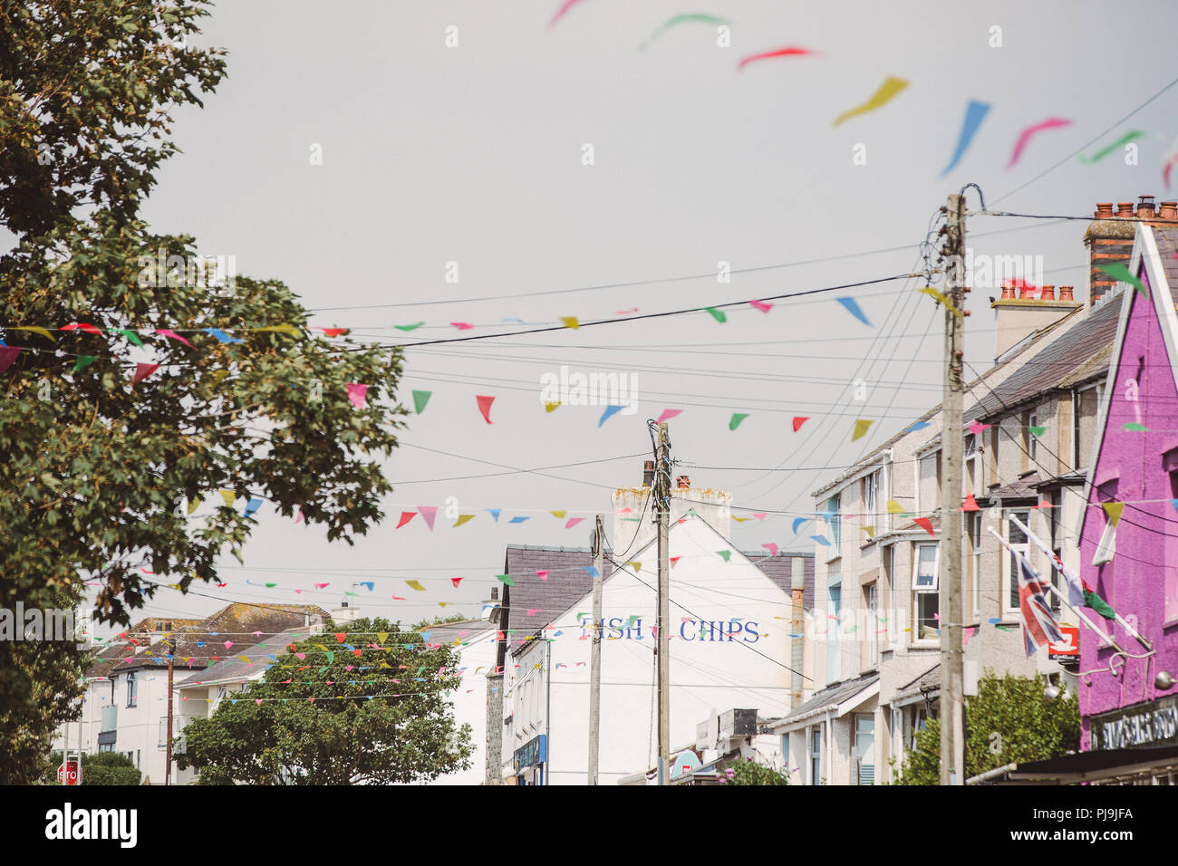 Bunting along Rhosneigr High Street, summer 2018 Stock Photo