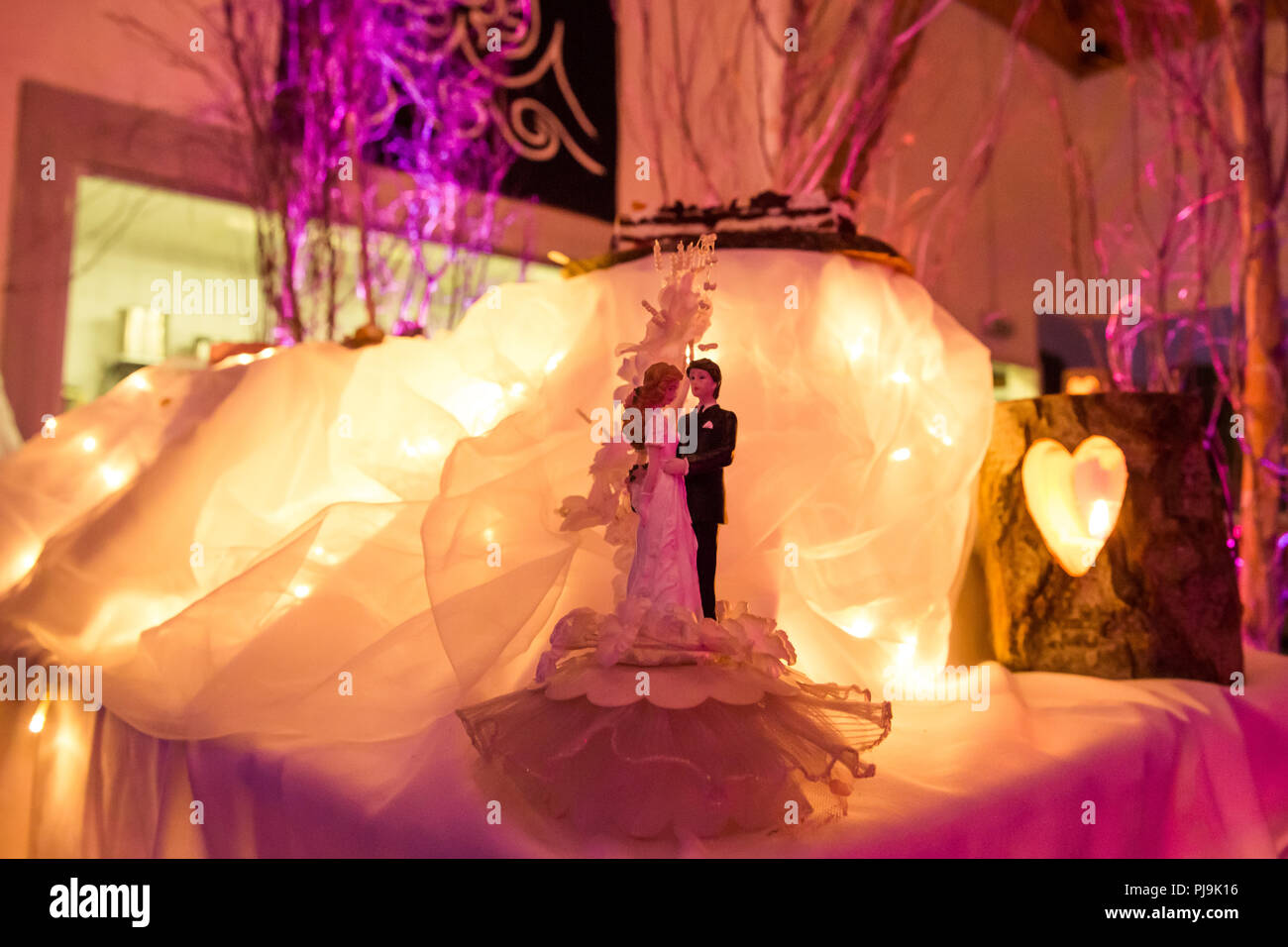 Bride & Groom Wedding Cake Decoration with Candle Light Stock Photo