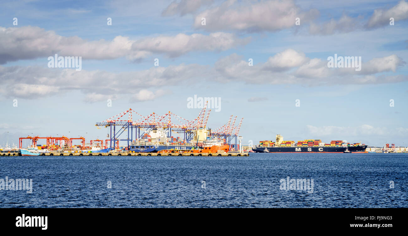 Commercial sea port with loading docks and equipment Stock Photo