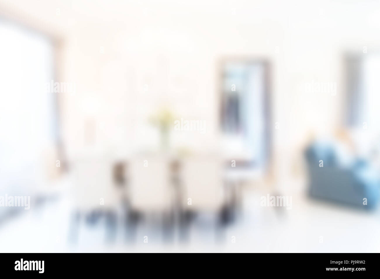 Blurred dining table next to sofa set in modern interior multipurpose area Stock Photo Alamy