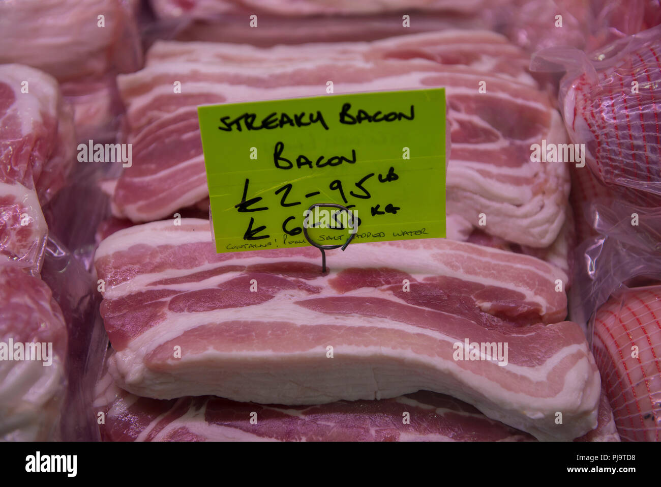 Bacon on sale at a butchers market. Stock Photo
