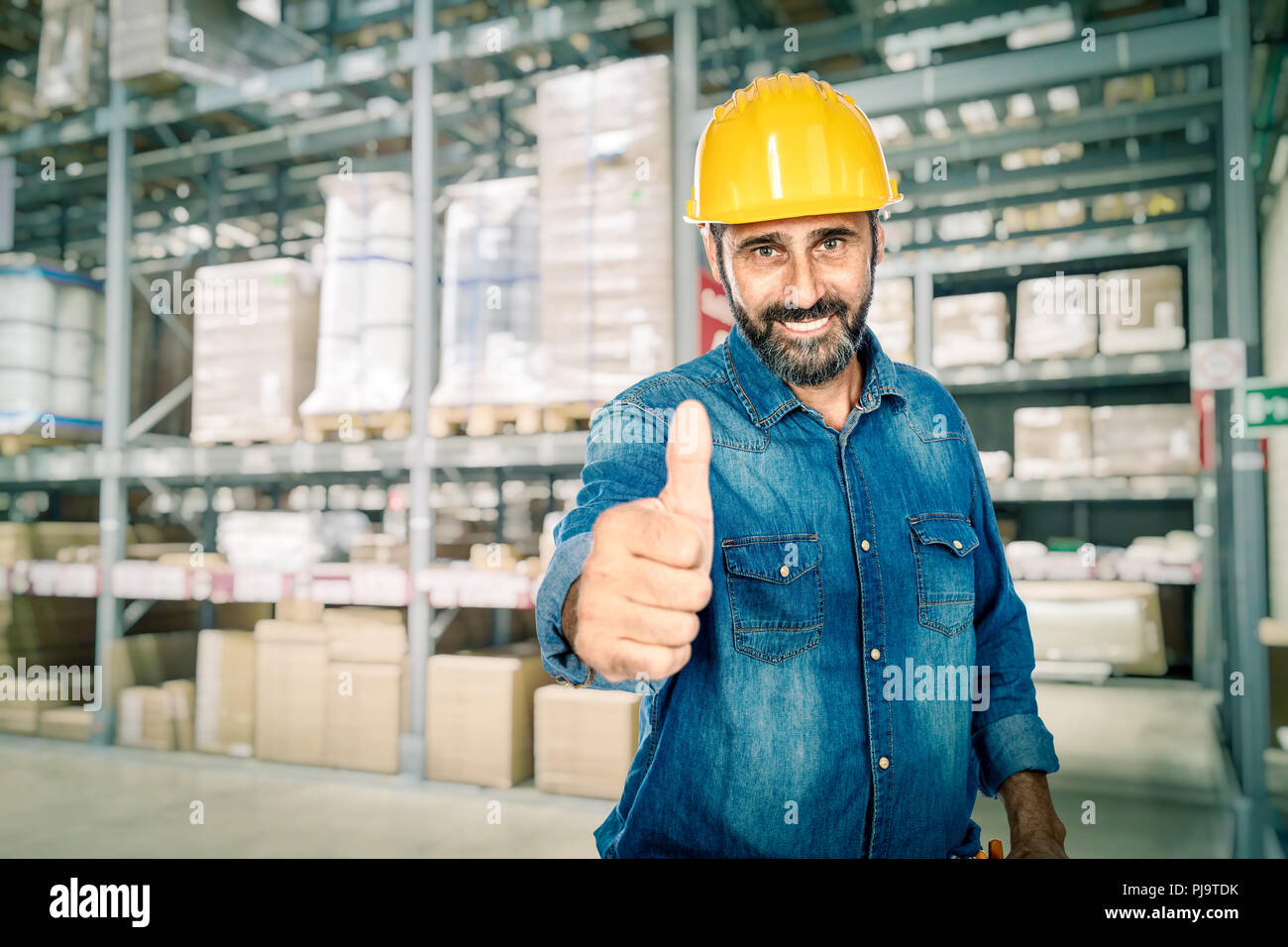 smiling caucasian handyman in warehouse Stock Photo