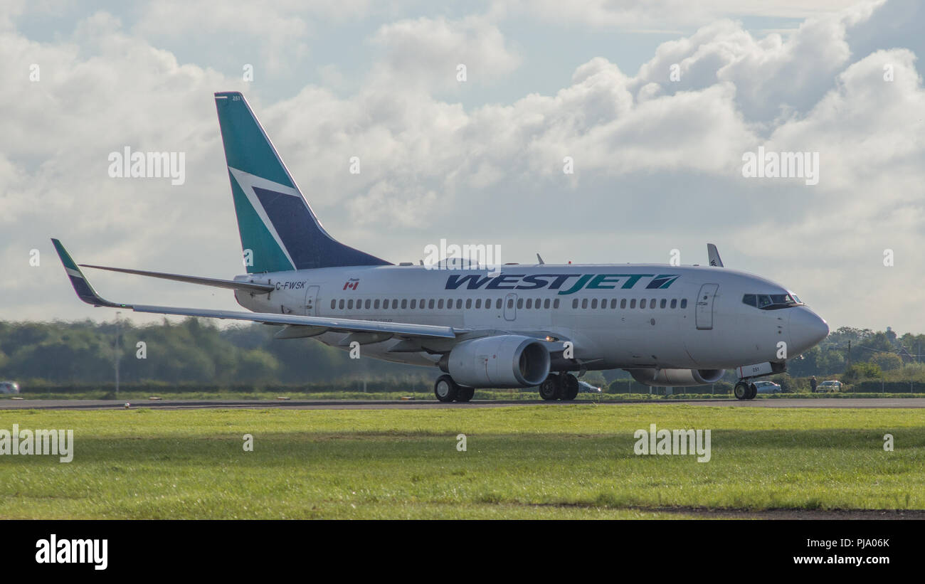 Westjet flight bound for Halifax Nova Scotia seen getting ready and departing Glasgow International Airport.  This was an introductory flight which ha Stock Photo