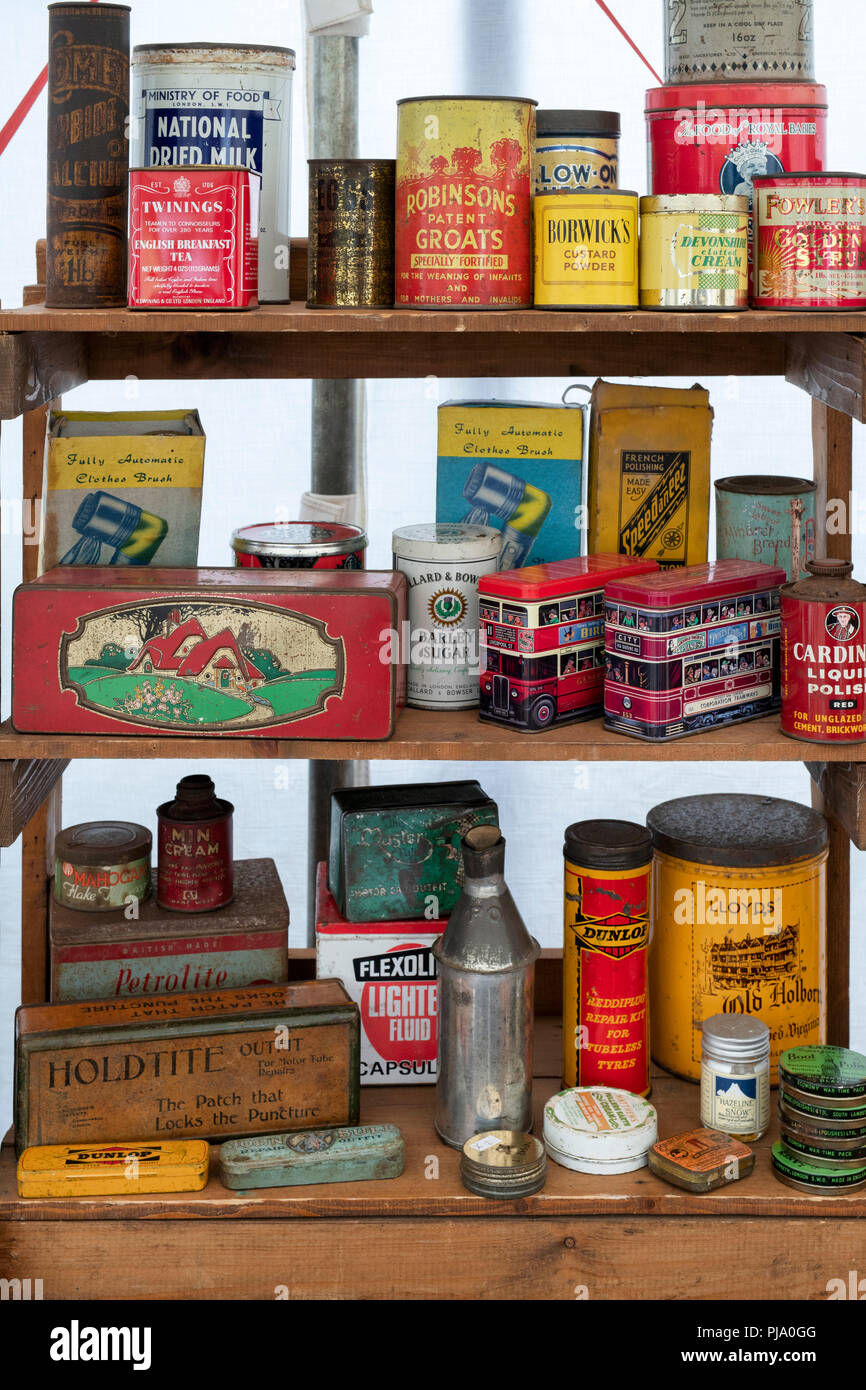 Collection of old metal tins on a stall at a vintage retro festival. UK Stock Photo