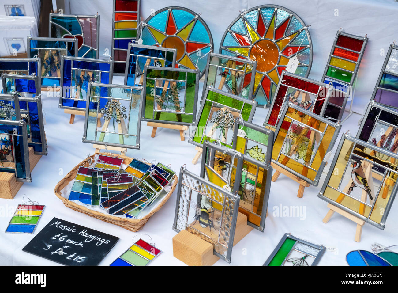 Colourful glass hangings for sale at Stroud farmers market. Stroud, Gloucestershire, England Stock Photo