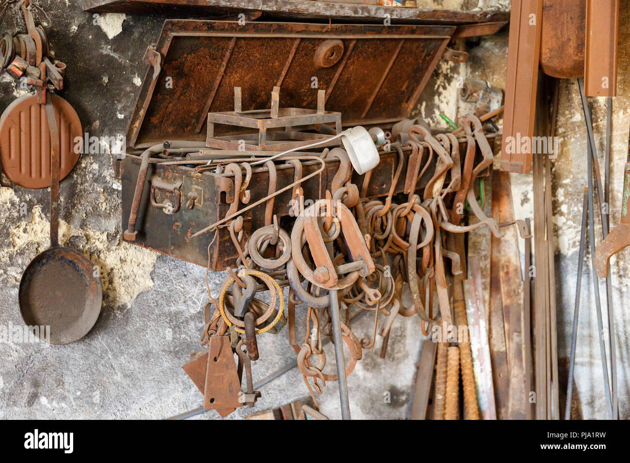 Old forged parts in a workshop Stock Photo